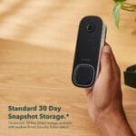 Smart video doorbell camera mounted on a modern entryway wall.