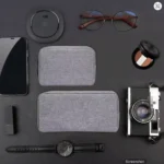 Electronics travel organizer bag open showing stored power bank, chargers, and cables inside mesh compartments.