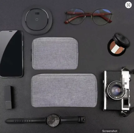 Electronics travel organizer bag open showing stored power bank, chargers, and cables inside mesh compartments.