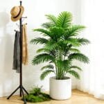 Artificial palm tree with lush green faux leaves in decorative white pot.